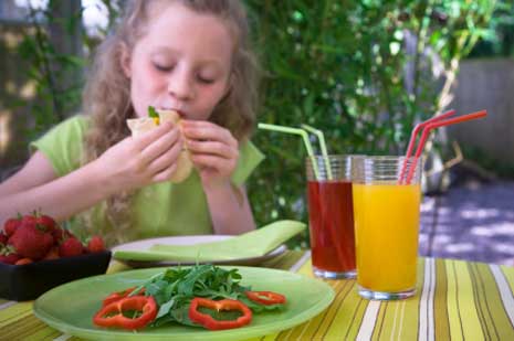 Child eating healthy food, salad, juice